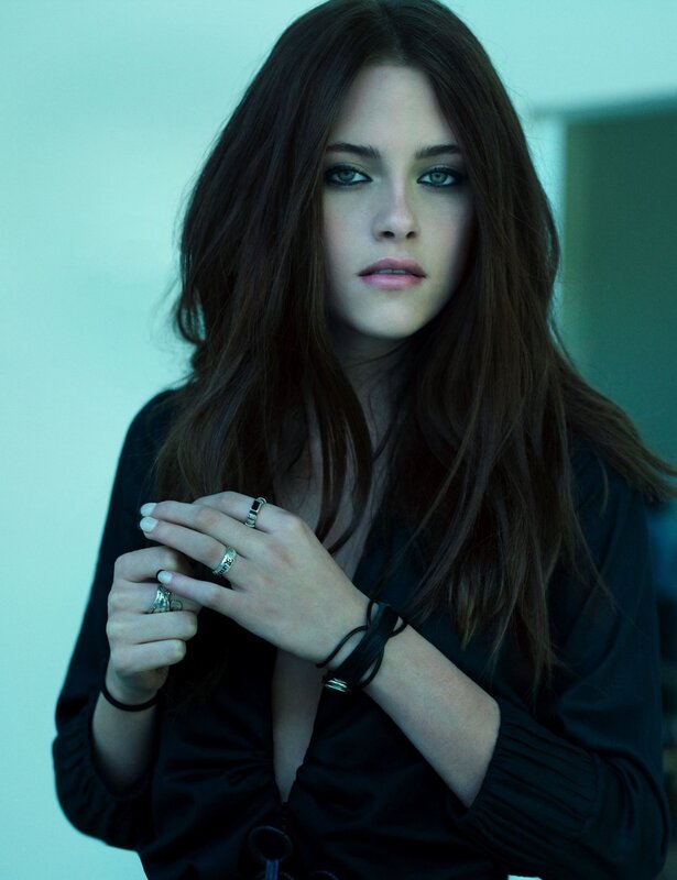 woman with dark hair and rings