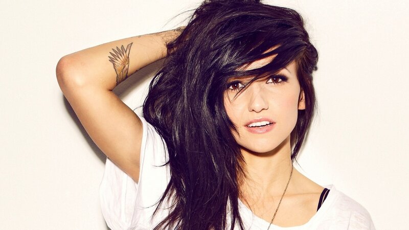 woman with dark hair and tattoo