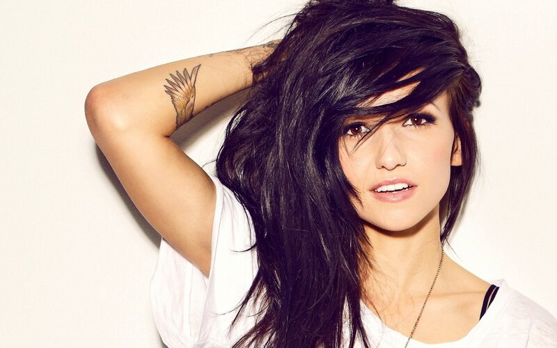 woman with dark hair and tattoo