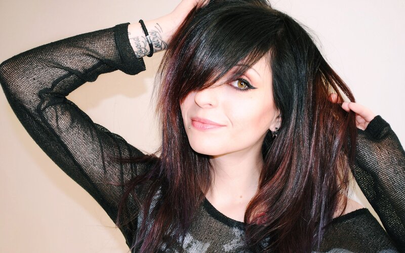 woman with dark hair and tattoos