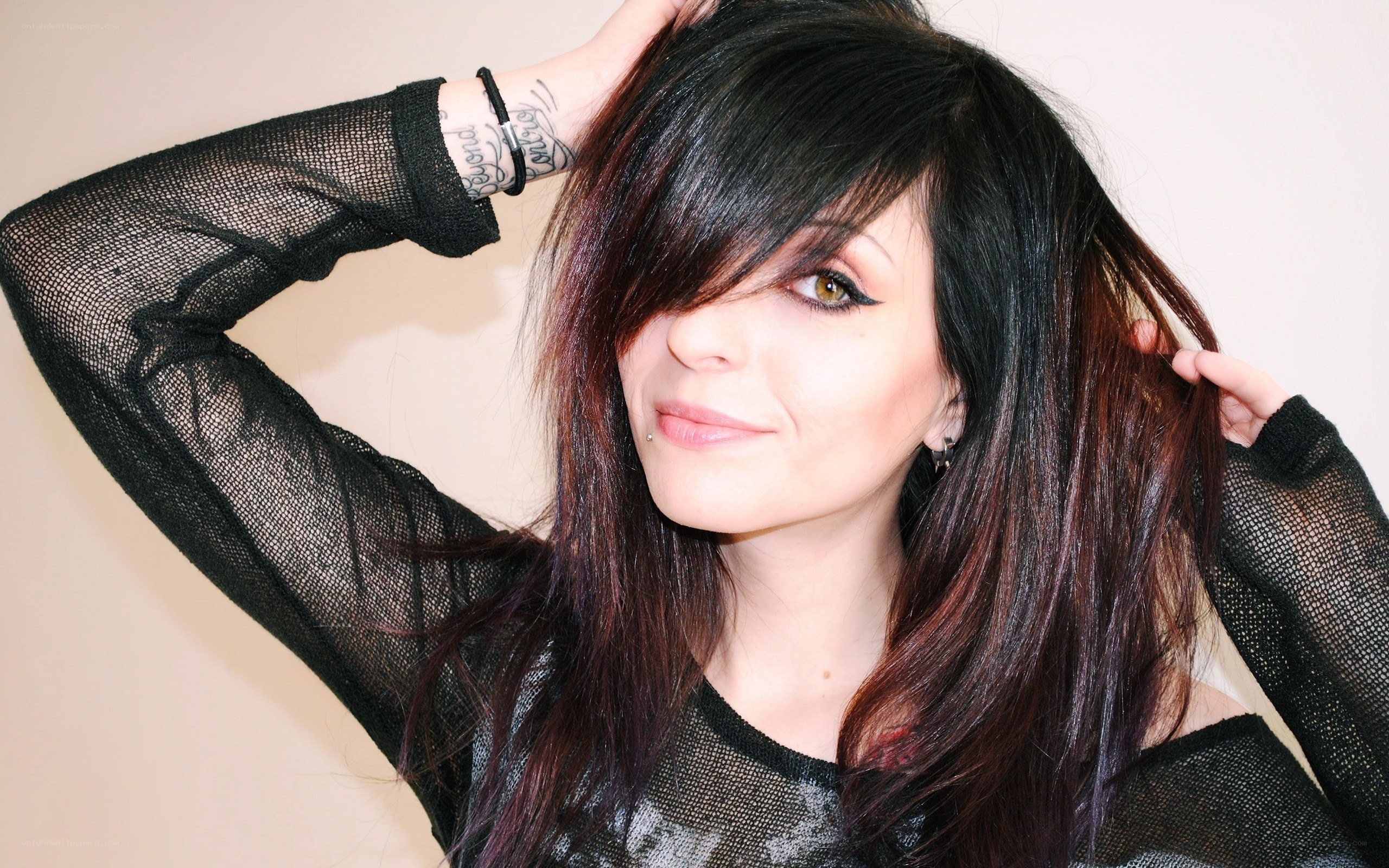 woman with dark hair and tattoos