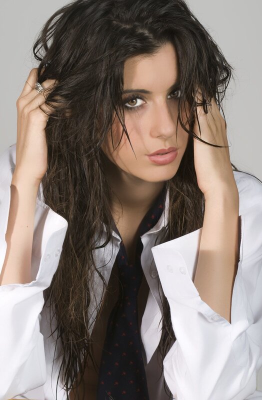 woman with dark hair and white shirt