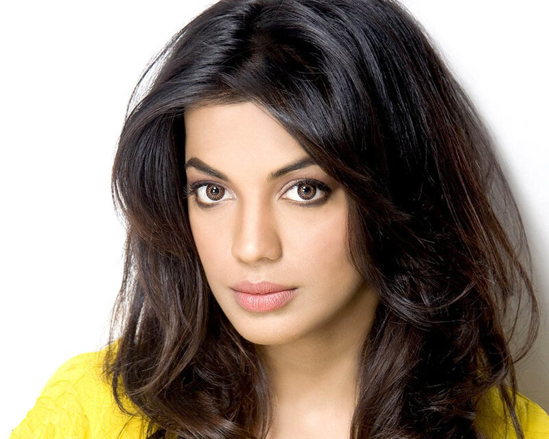woman with dark hair and yellow top