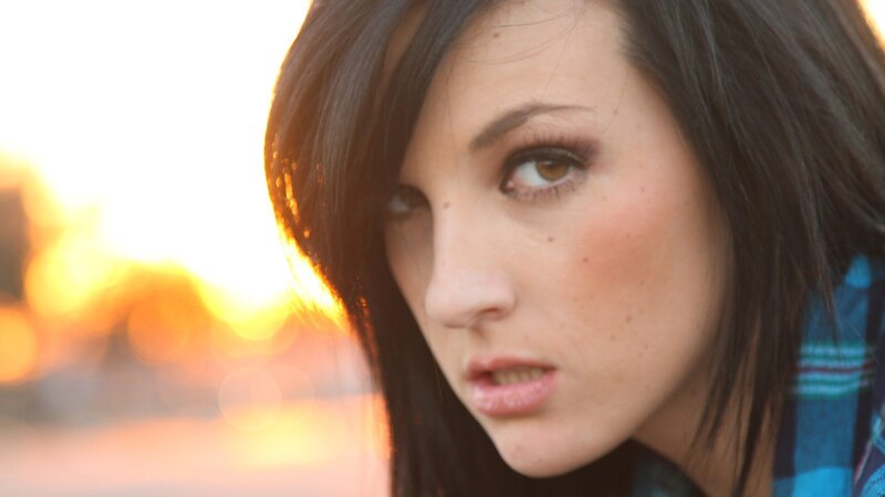 woman with dark hair at sunset