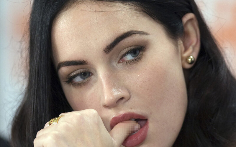 woman with dark hair biting finger