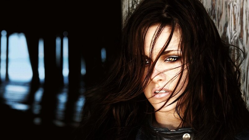 Woman with Dark Hair — Black, Dramatic, Photograph, Leather Jacket, Wood Wall