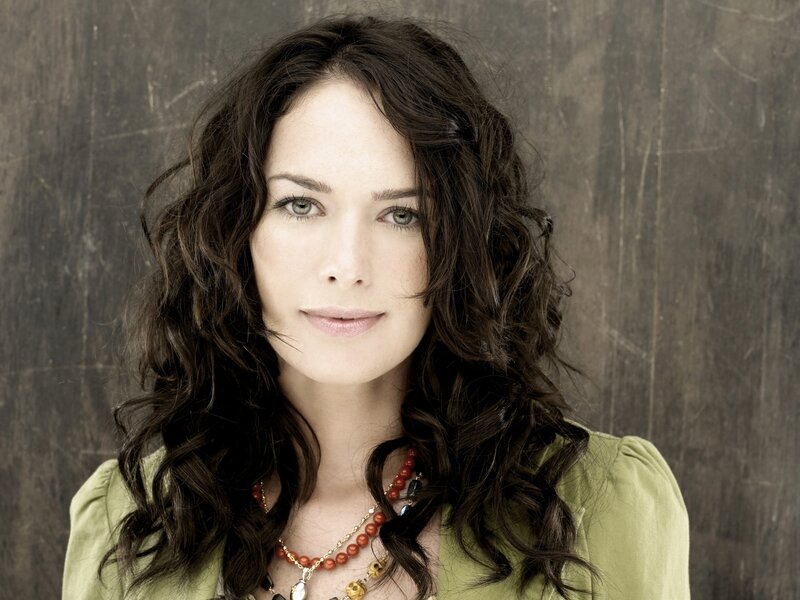 Woman with Dark Hair — Brown, Neutral, Photograph, Necklace, Green Shirt, Wooden Wall, Green, Beige