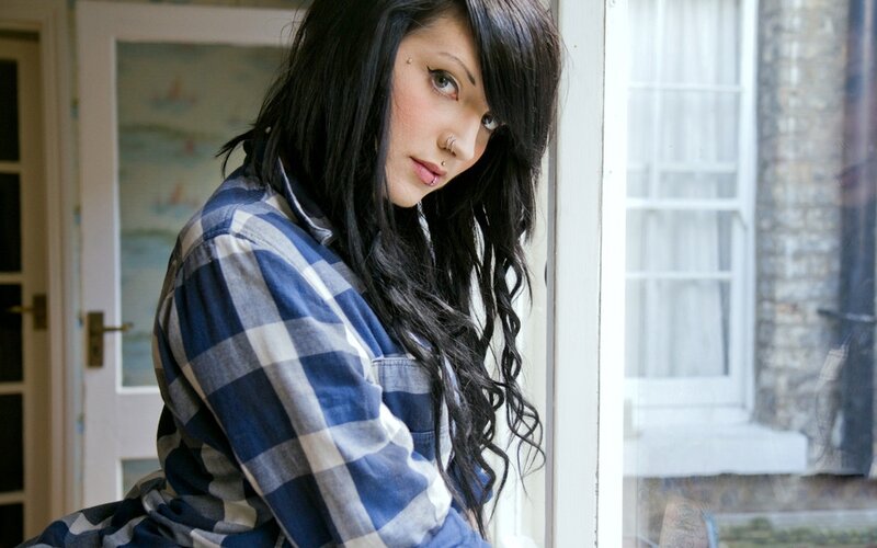 woman with dark hair by window