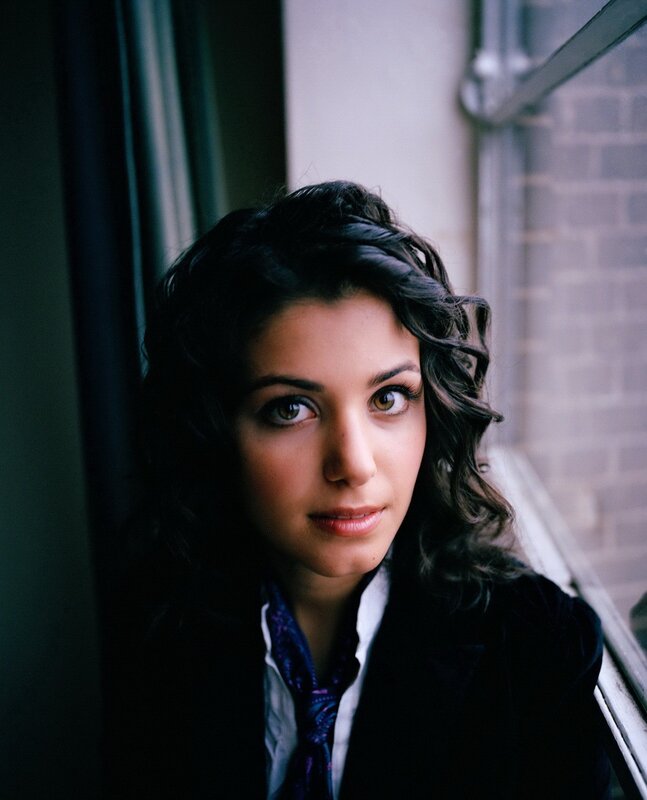 woman with dark hair by window