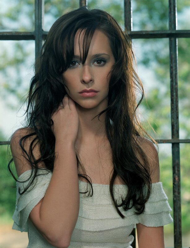 woman with dark hair by window