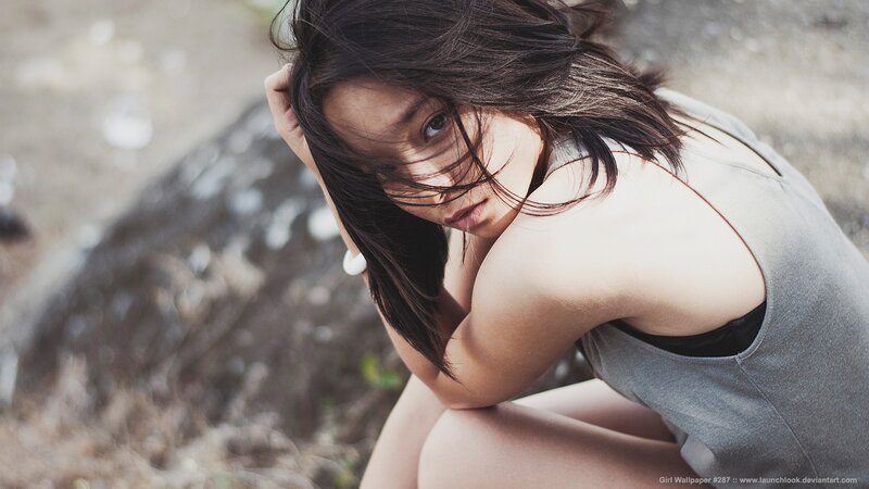 woman with dark hair crouching