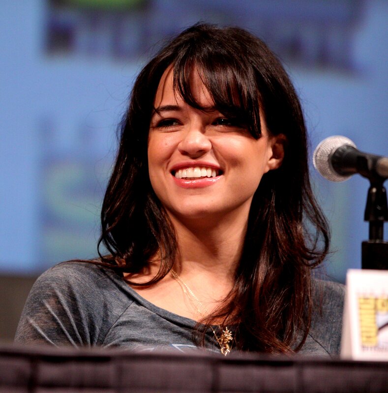 Woman with Dark Hair — Gray, Smiling, Photograph, Microphone