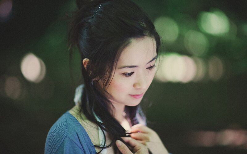 woman with dark hair in a blue sweater