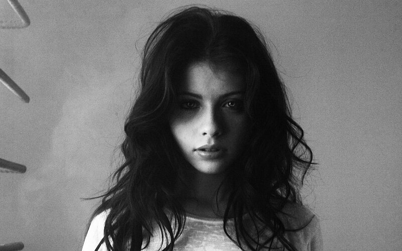 woman with dark hair in black and white
