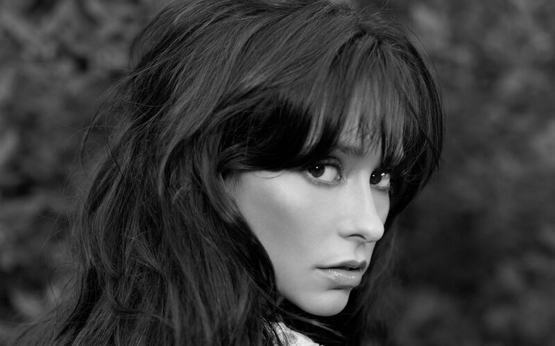 woman with dark hair in black and white