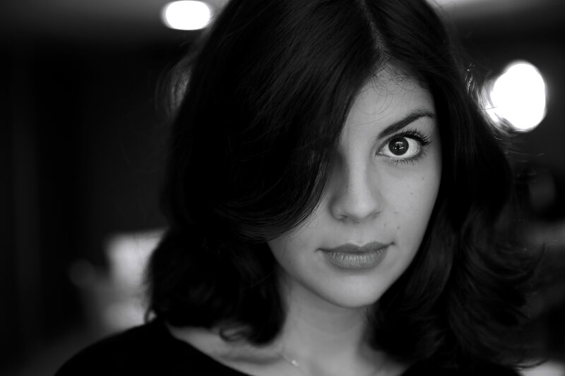 woman with dark hair in black and white