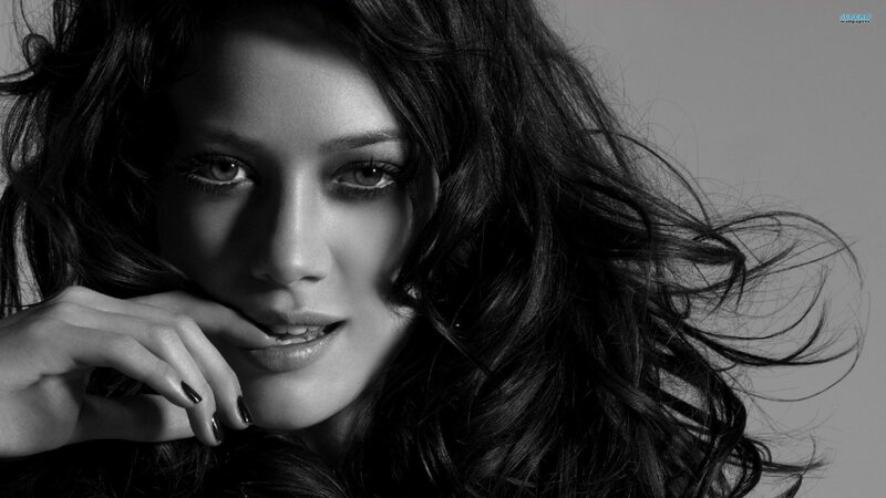 woman with dark hair in black and white