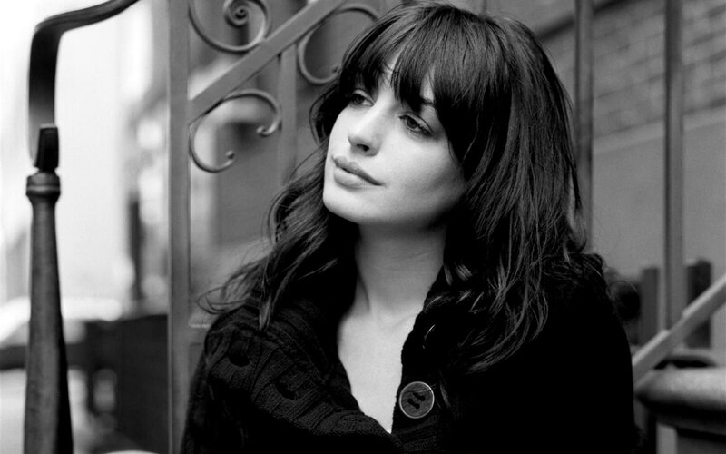 woman with dark hair in black and white