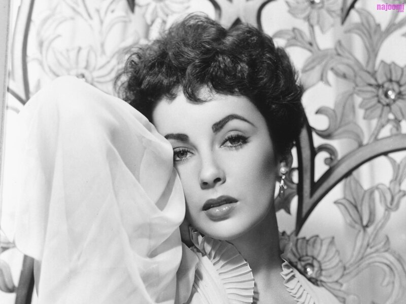 woman with dark hair in black and white