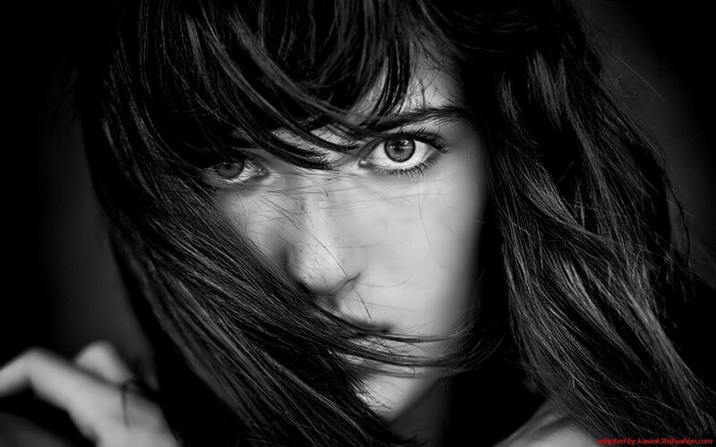 woman with dark hair in black and white