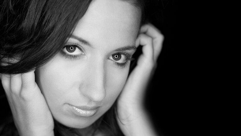 woman with dark hair in black and white