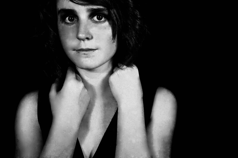 woman with dark hair in black and white