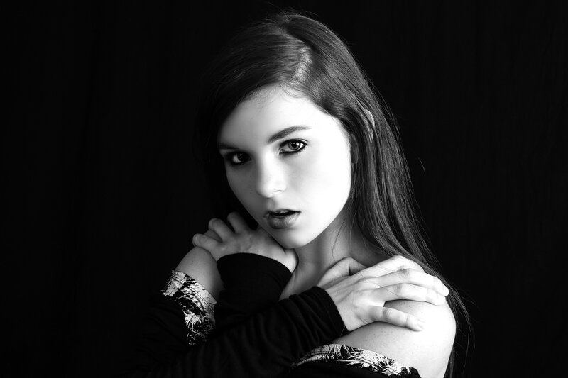 woman with dark hair in black and white