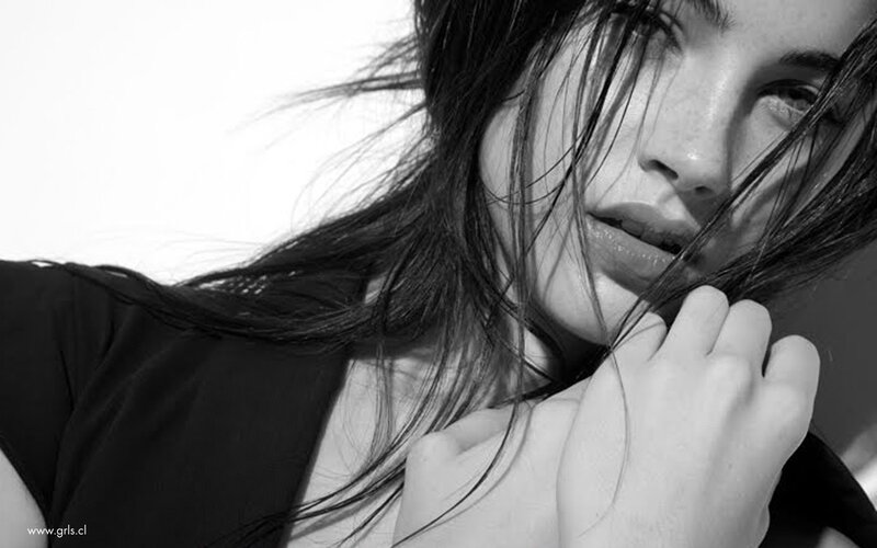 woman with dark hair in black and white