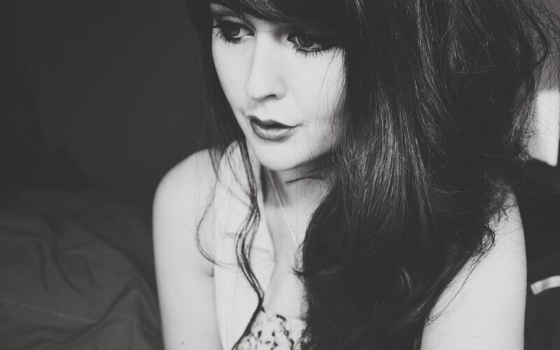 woman with dark hair in black and white