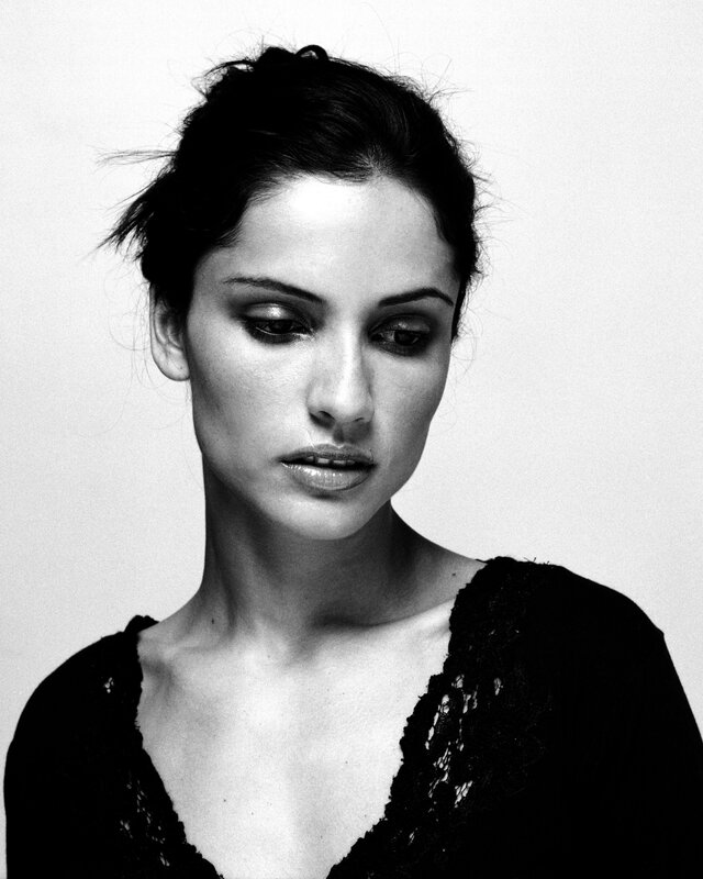 woman with dark hair in black and white