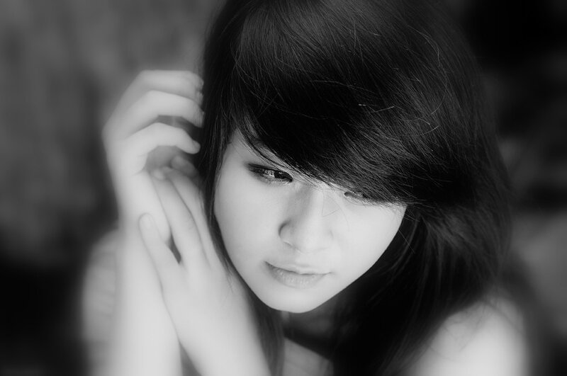 woman with dark hair in black and white