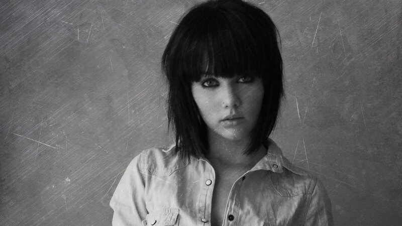 woman with dark hair in black and white