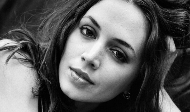 woman with dark hair in black and white