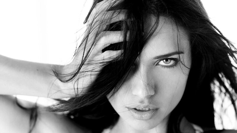 woman with dark hair in black and white