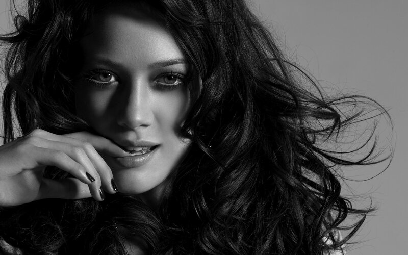 woman with dark hair in black and white