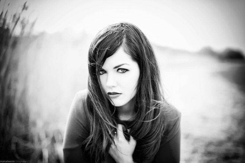 woman with dark hair in black and white