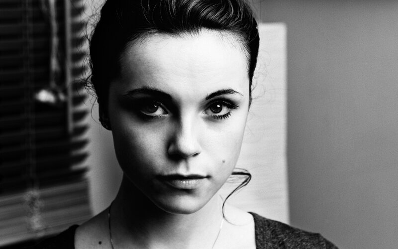 woman with dark hair in black and white