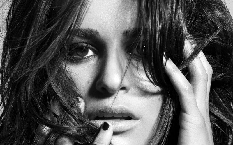 woman with dark hair in black and white