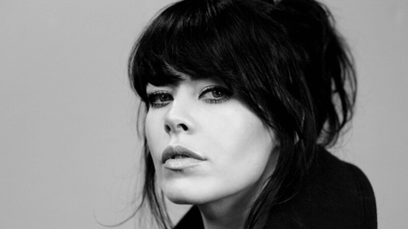 woman with dark hair in black and white
