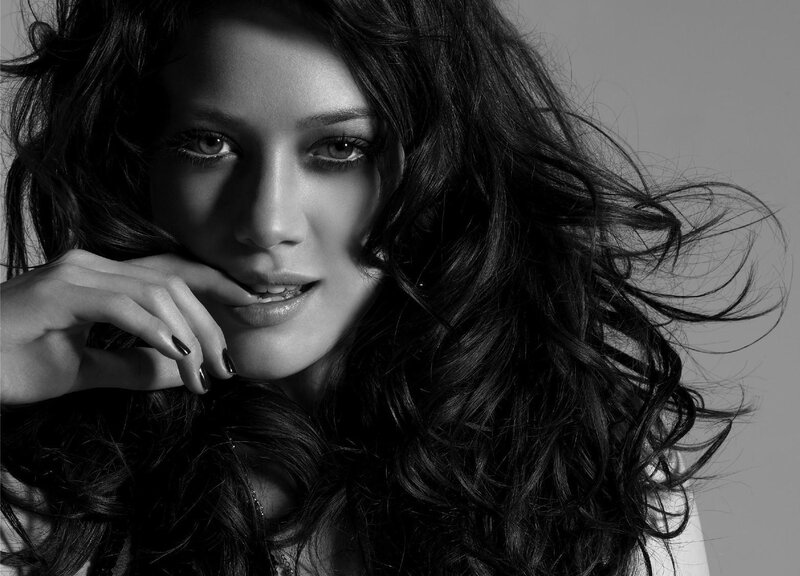 woman with dark hair in black and white