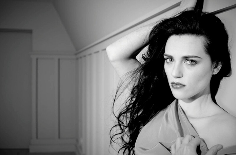 woman with dark hair in black and white