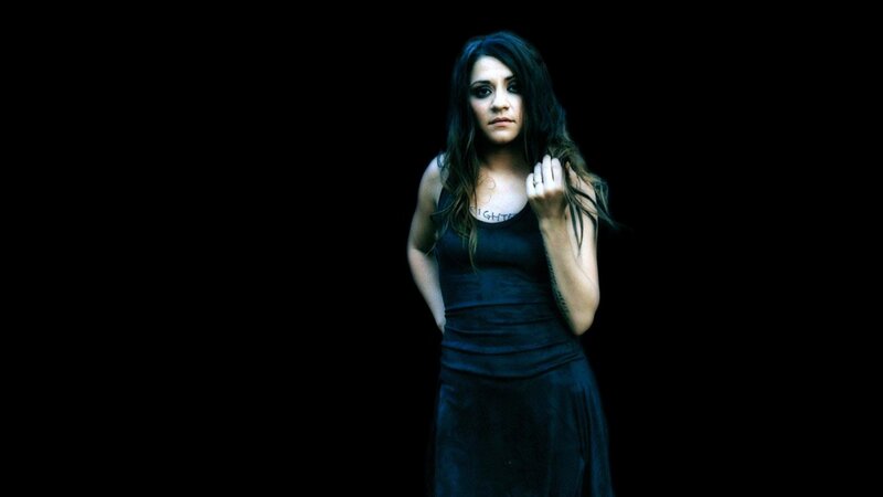 woman with dark hair in black dress