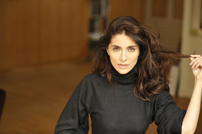woman with dark hair in black sweater