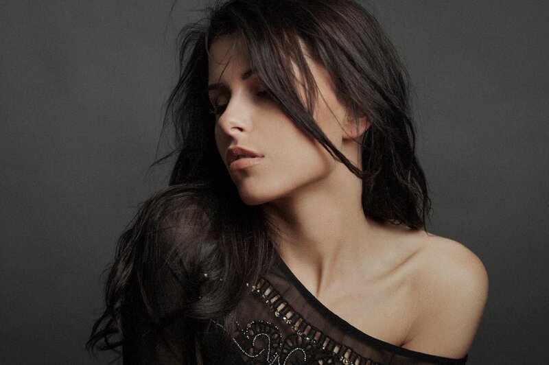 woman with dark hair in black top