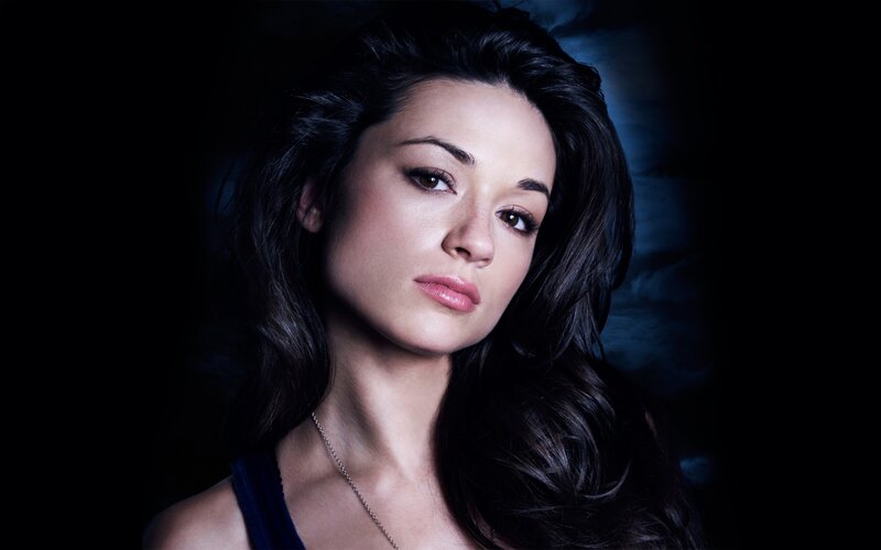 woman with dark hair in blue light