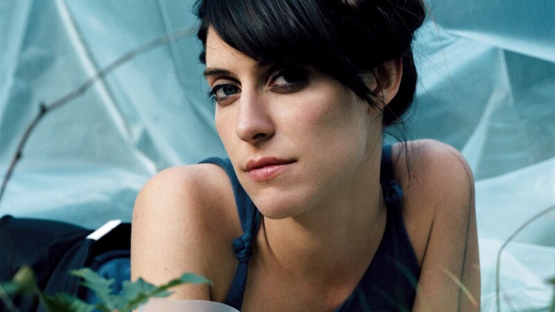 woman with dark hair in blue setting