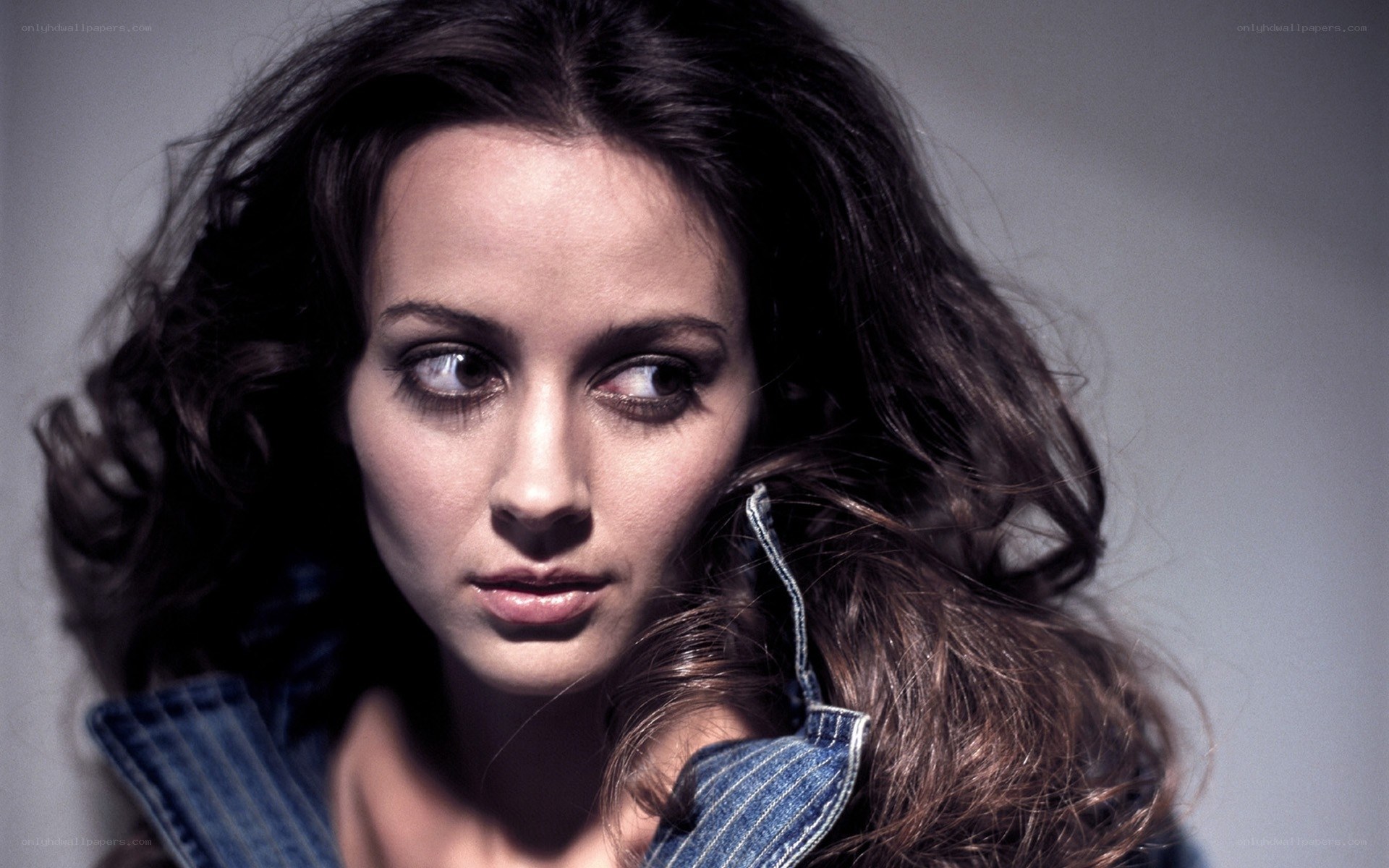 woman with dark hair in denim jacket