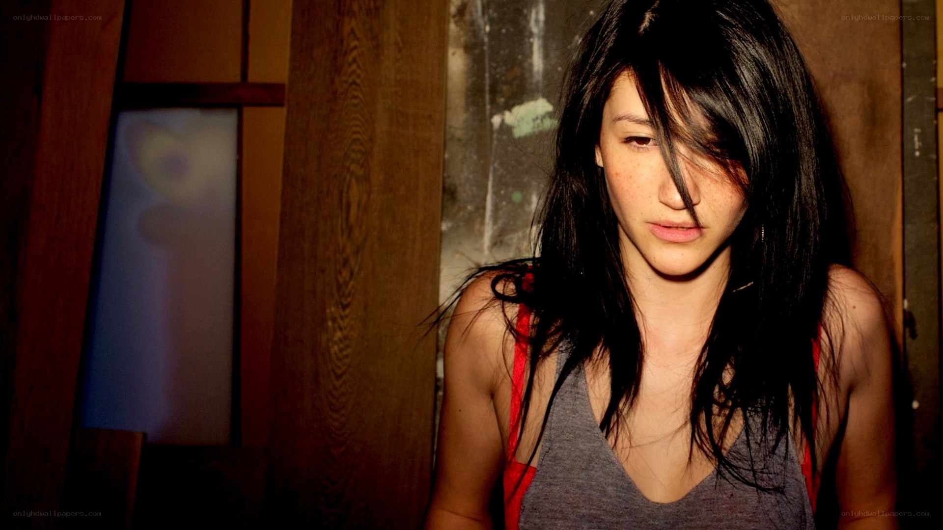 woman with dark hair in dim light