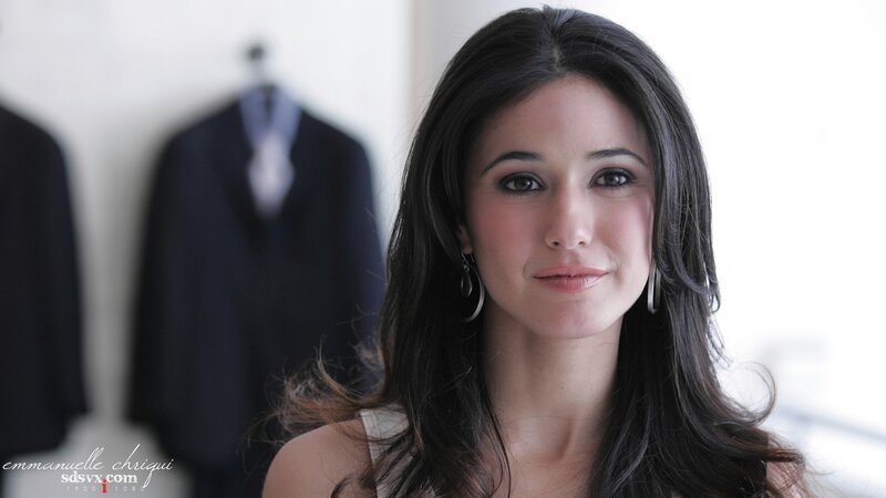 woman with dark hair in front of suits