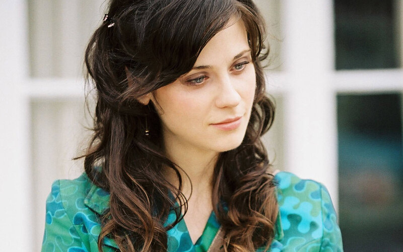 woman with dark hair in green dress